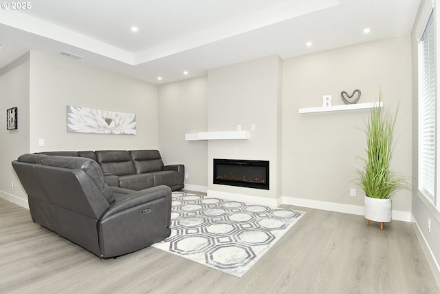 living area with visible vents, recessed lighting, baseboards, and wood finished floors