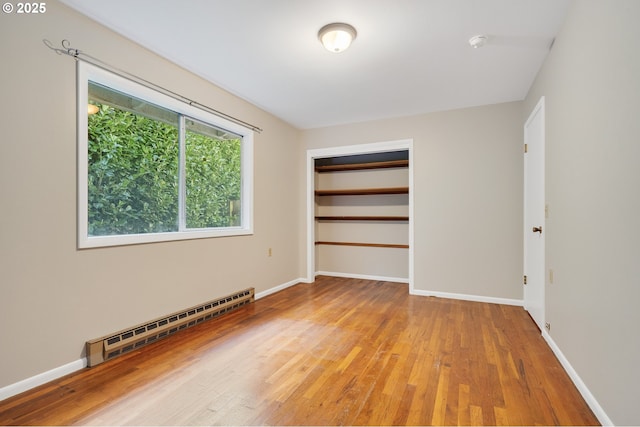 1806 8th St, Tillamook, OR 97141 - empty room with baseboards, light wood-style flooring, and a baseboard radiator