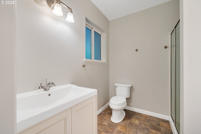 1806 8th St, Tillamook, OR 97141 - bathroom featuring vanity, toilet, stone finish floor, baseboards, and a stall shower