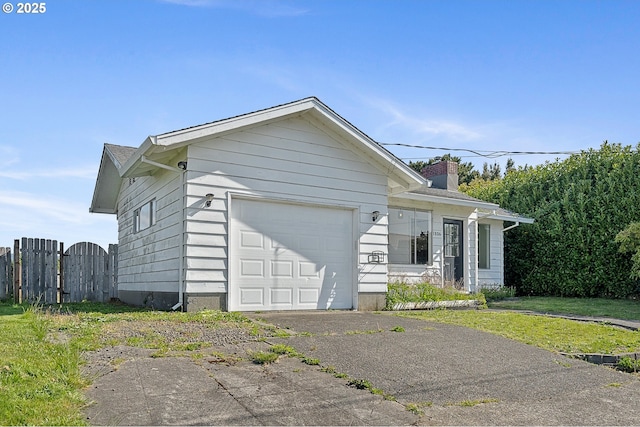 1806 8th St, Tillamook, OR 97141 - view of side of home with fence, a chimney, a gate, an attached garage, and driveway