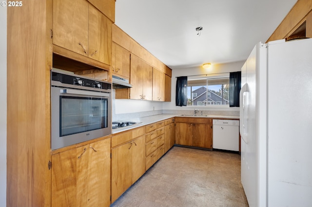 1806 8th St, Tillamook, OR 97141 - kitchen with white appliances, under cabinet range hood, a sink, and light countertops