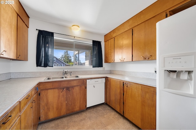 1806 8th St, Tillamook, OR 97141 - kitchen featuring brown cabinetry, a sink, white appliances, and light countertops