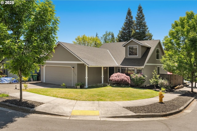 view of front facade with a garage, a front lawn, a shingled roof, and driveway