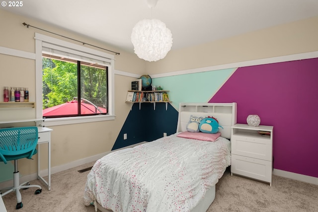 bedroom with carpet flooring, a chandelier, and baseboards