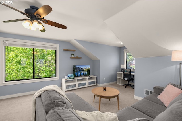 carpeted living area featuring baseboards, vaulted ceiling, a ceiling fan, and an office area