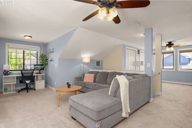 living room with ceiling fan, light carpet, a desk, and baseboards