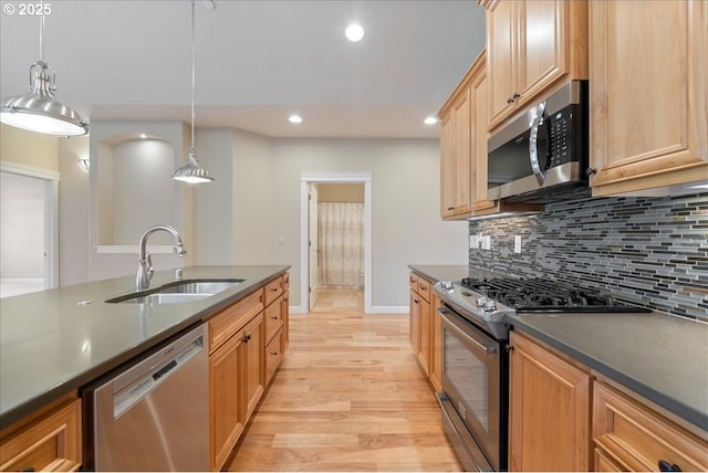 5809 NW 26th Ave, Camas, WA 98607 - kitchen with appliances with stainless steel finishes, dark countertops, light wood-style floors, backsplash, and recessed lighting