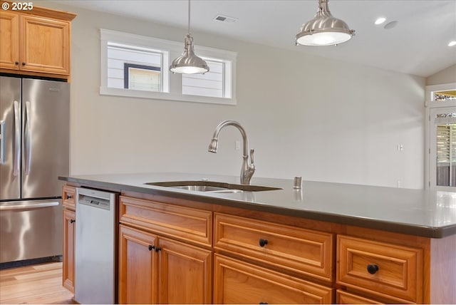 5809 NW 26th Ave, Camas, WA 98607 - kitchen featuring appliances with stainless steel finishes, light wood-style floors, pendant lighting, and brown cabinets