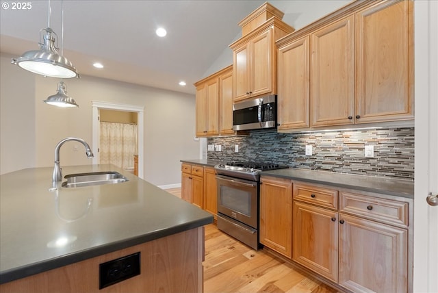 5809 NW 26th Ave, Camas, WA 98607 - kitchen featuring appliances with stainless steel finishes, dark countertops, light wood-type flooring, tasteful backsplash, and recessed lighting