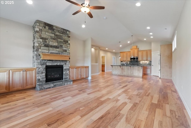 5809 NW 26th Ave, Camas, WA 98607 - unfurnished living room with vaulted ceiling, ceiling fan, light wood finished floors, a fireplace, and recessed lighting
