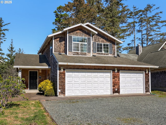 view of front of property with an attached garage, driveway, and a shingled roof