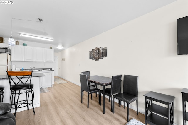 304 14th St NW Unit 304, Long Beach, WA 98631 - dining room featuring light wood-style floors and baseboards