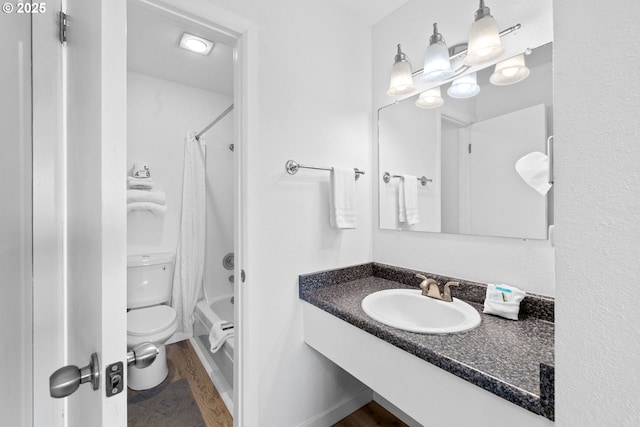 304 14th St NW Unit 304, Long Beach, WA 98631 - bathroom with toilet, vanity, shower / bath combination with curtain, and wood finished floors
