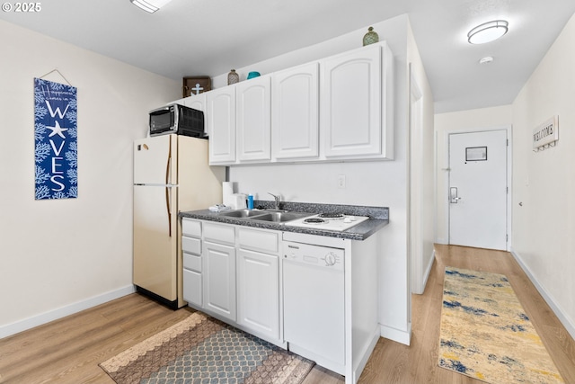 304 14th St NW Unit 304, Long Beach, WA 98631 - kitchen featuring white appliances, a sink, dark countertops, and light wood finished floors