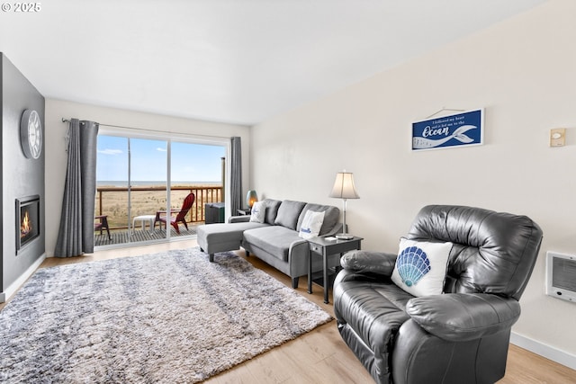304 14th St NW Unit 304, Long Beach, WA 98631 - living room featuring light wood-type flooring, baseboards, and heating unit