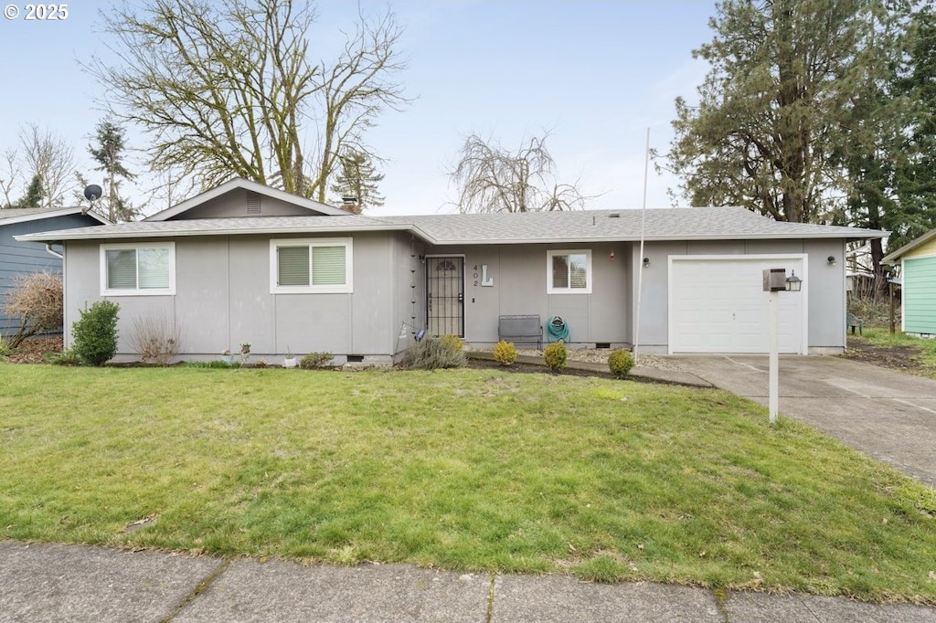 ranch-style house with a garage and a front lawn