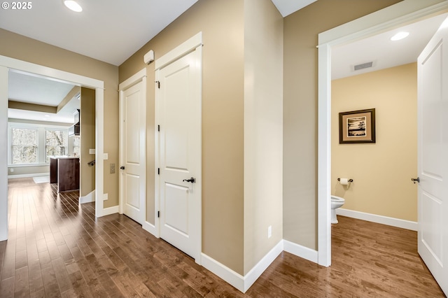 7705 NW Quinault St, Camas, WA 98607 - corridor featuring wood finished floors, baseboards, visible vents, and recessed lighting