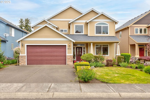 16710 NE 5th St, Vancouver, WA 98684 - view of front of property featuring concrete driveway, an attached garage, a front yard, stone siding, and roof with shingles