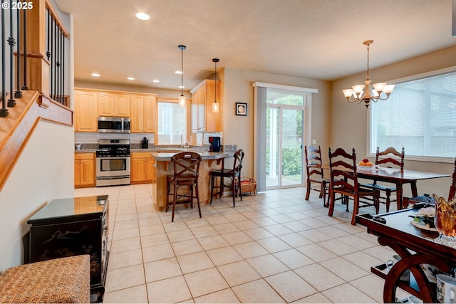 16710 NE 5th St, Vancouver, WA 98684 - kitchen with appliances with stainless steel finishes, recessed lighting, a chandelier, light tile patterned floors, and a kitchen bar