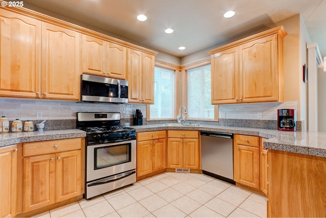 16710 NE 5th St, Vancouver, WA 98684 - kitchen with stainless steel appliances, a sink, tile counters, light brown cabinets, and recessed lighting