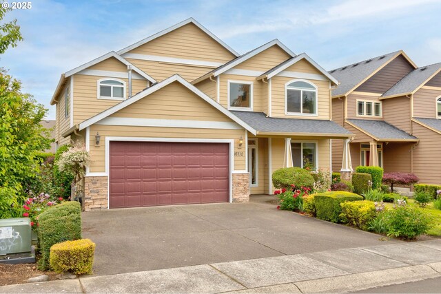 16710 NE 5th St, Vancouver, WA 98684 - view of front of home featuring stone siding, concrete driveway, and a garage