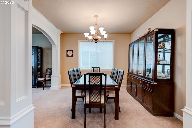 16710 NE 5th St, Vancouver, WA 98684 - dining space featuring arched walkways, a chandelier, light carpet, healthy amount of natural light, and a textured ceiling