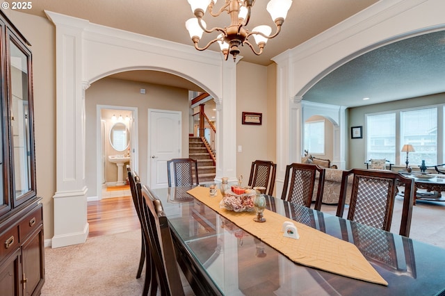 16710 NE 5th St, Vancouver, WA 98684 - dining area with arched walkways, stairs, light carpet, and a chandelier