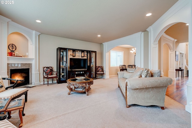 16710 NE 5th St, Vancouver, WA 98684 - carpeted living area featuring arched walkways, a tiled fireplace, recessed lighting, and baseboards