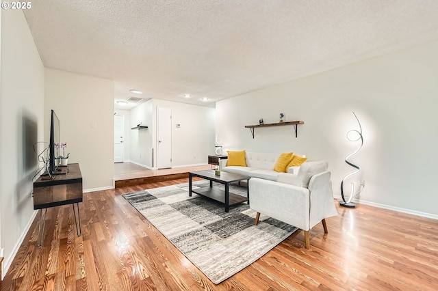 6650 SW Dale Ave, Beaverton, OR 97008 - living room with wood finished floors, baseboards, a textured ceiling, and recessed lighting