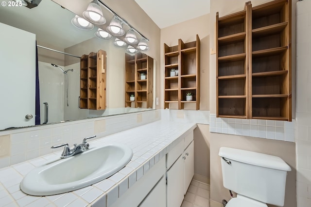 6650 SW Dale Ave, Beaverton, OR 97008 - full bathroom with vanity, toilet, a shower, tasteful backsplash, and tile patterned floors