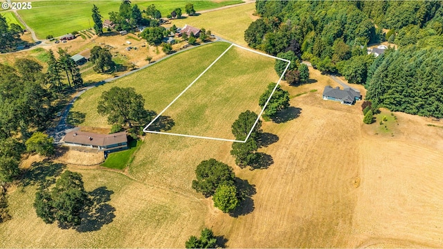 birds eye view of property with a rural view