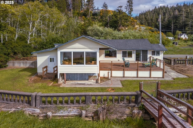 57569 Parkersburg Rd, Bandon, OR 97411 - rear view of house featuring a deck and a wooded view