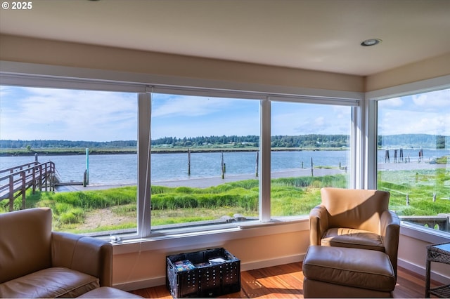 57569 Parkersburg Rd, Bandon, OR 97411 - living area featuring baseboards, wood finished floors, a water view, and recessed lighting