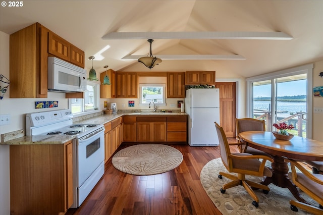 57569 Parkersburg Rd, Bandon, OR 97411 - kitchen featuring white appliances, brown cabinetry, dark wood-type flooring, pendant lighting, and light stone countertops