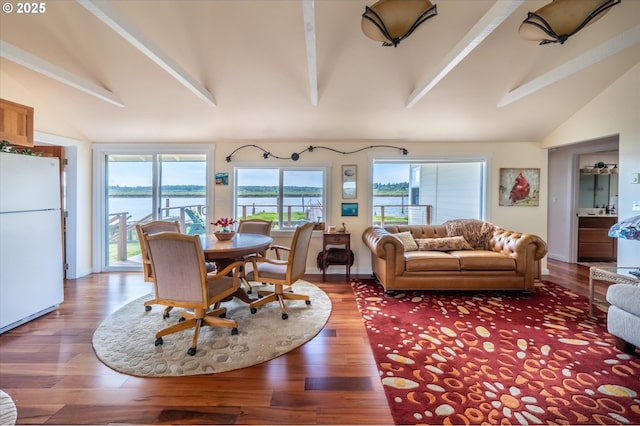 57569 Parkersburg Rd, Bandon, OR 97411 - dining area featuring beamed ceiling, wood finished floors, a water view, and high vaulted ceiling