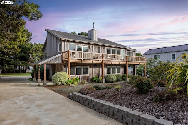 back house at dusk with a deck