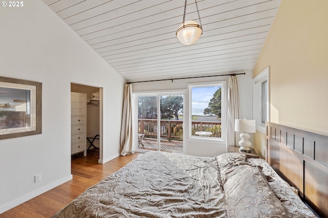 bedroom with vaulted ceiling, a walk in closet, access to exterior, wooden ceiling, and light hardwood / wood-style flooring