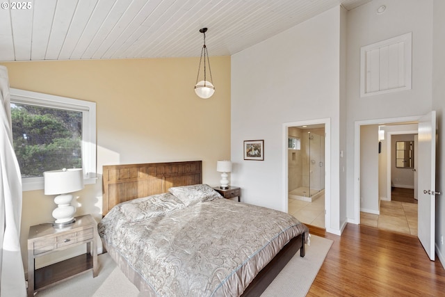 bedroom featuring lofted ceiling, wood ceiling, and wood-type flooring