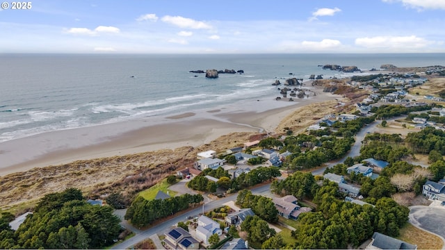 drone / aerial view with a water view and a view of the beach