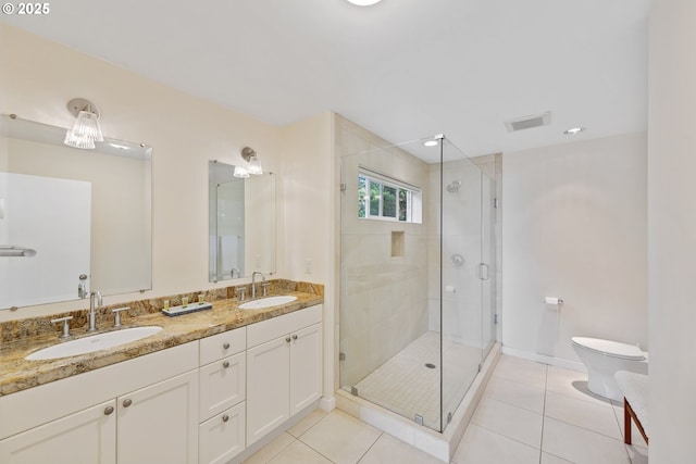 bathroom with toilet, vanity, tile patterned floors, and walk in shower