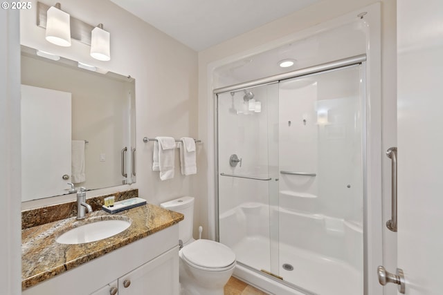 bathroom featuring walk in shower, vanity, and toilet