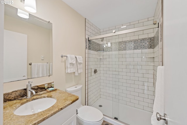 bathroom with vanity, walk in shower, and toilet