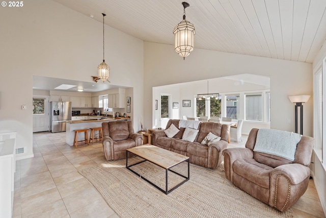 tiled living room featuring lofted ceiling, sink, and wooden ceiling