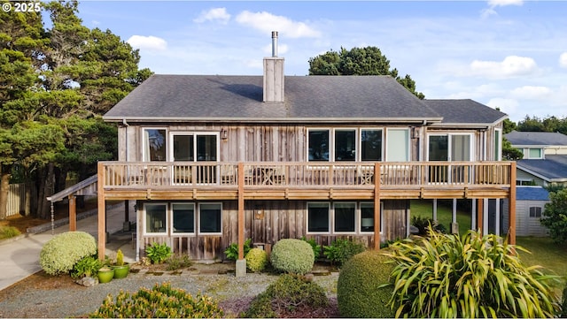 rear view of house featuring a deck