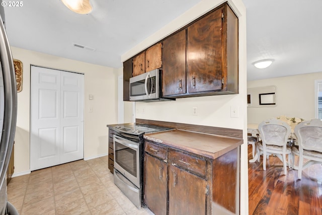 2280 Dakota St, Eugene, OR 97402 - kitchen with appliances with stainless steel finishes, dark brown cabinetry, and baseboards