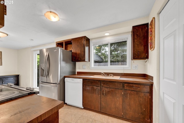 2280 Dakota St, Eugene, OR 97402 - kitchen featuring dishwasher, a sink, stainless steel refrigerator with ice dispenser, dark brown cabinets, and butcher block counters