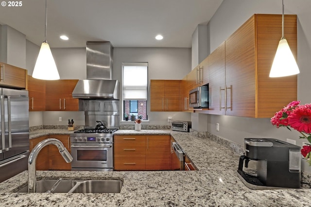 1746 NW Riverscape St, Portland, OR 97209 - kitchen with wall chimney exhaust hood, premium appliances, a sink, brown cabinetry, and light stone countertops
