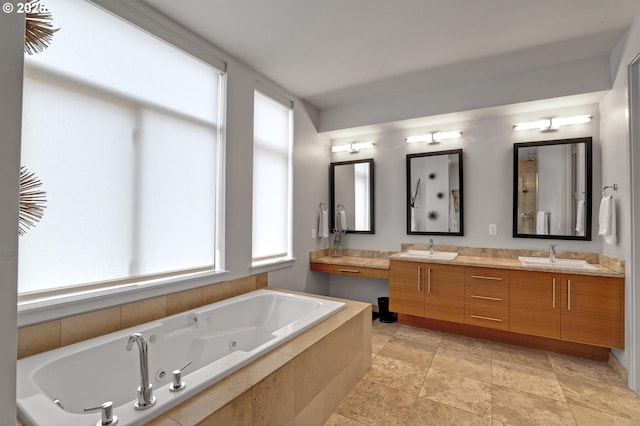 1746 NW Riverscape St, Portland, OR 97209 - full bathroom with double vanity, a jetted tub, and stone finish flooring