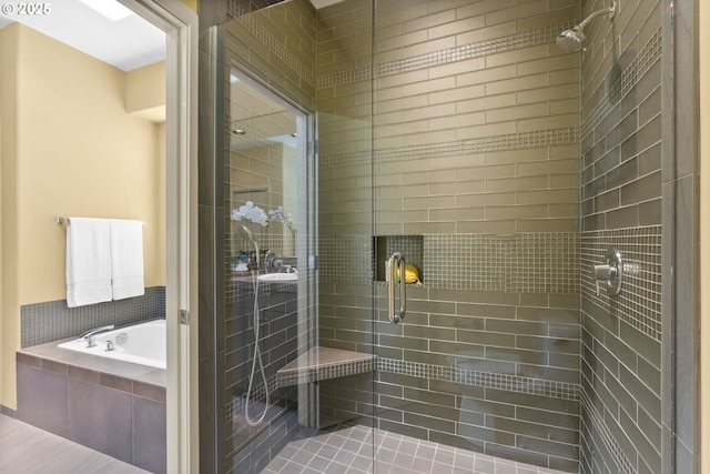 bathroom featuring shower with separate bathtub