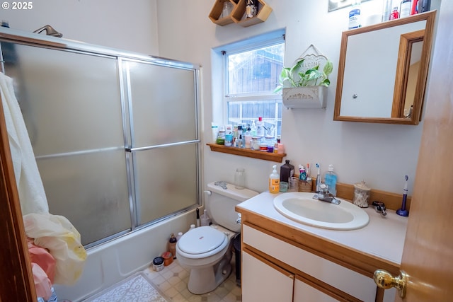 full bathroom with vanity, combined bath / shower with glass door, and toilet